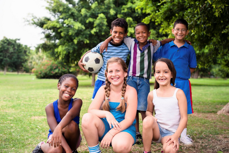 Group of kids posing with soccer ball
