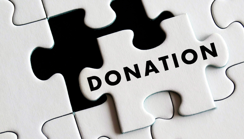 White puzzle piece with word Donation