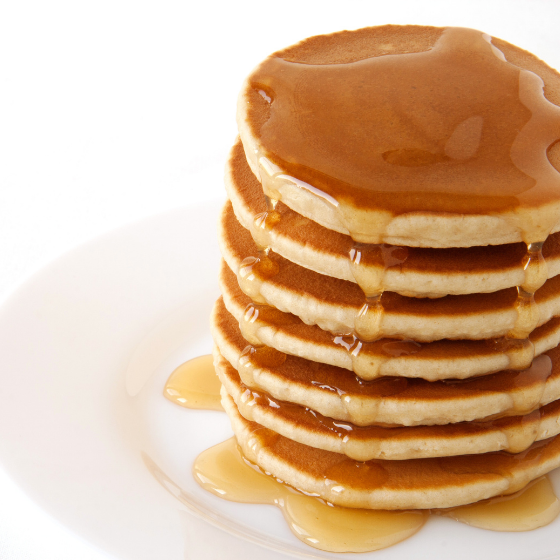Close up image of pancakes covered in syrup